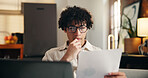 Document, thinking and man in home for remote work, accounting budget or chart for audit report. Paperwork, serious person and freelancer reading in house for income taxes, data or problem solving