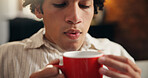 Blow, coffee and hot with man in home living room for caffeine, start of morning or weekend. Beverage, relax and rest with person cooling drink in apartment for break, stress relief or wellness
