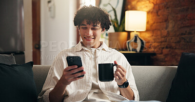 Buy stock photo Coffee, relax and man on sofa with phone for social media, online message and chat in home. Weekend, smile and person on smartphone for internet, connection and notification on mobile app with drink