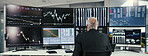Mature, businessman or broker monitoring with stock market on computer for online trading. Back view, man or investor checking graph, statistics or cryptocurrency for investment exchange in workplace
