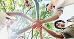 Below, hand stack and huddle with friends outdoor together for solidarity, support or unity. Diversity, success and trees with group of people in nature for collaboration, motivation or teamwork