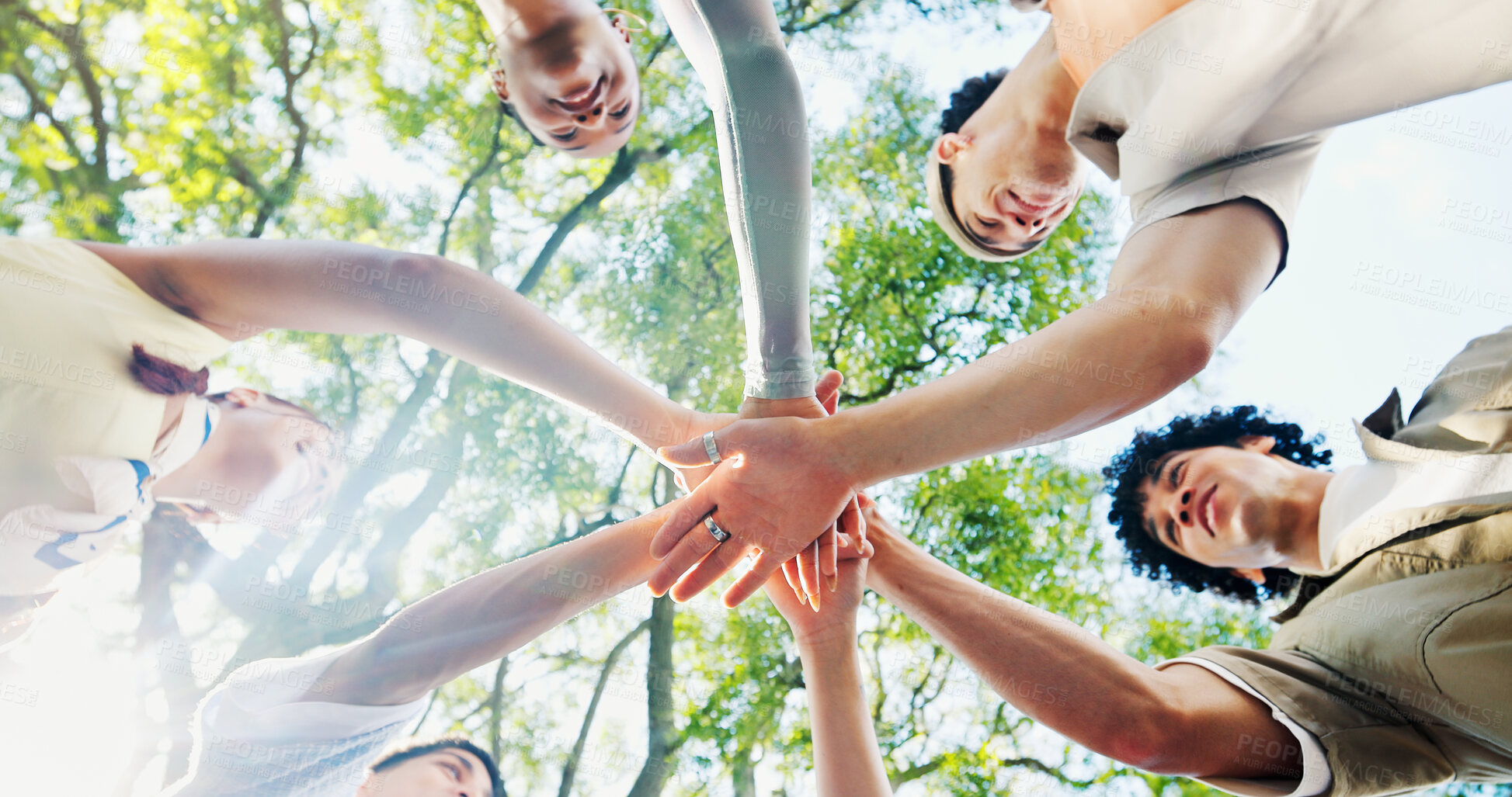 Buy stock photo Below, hand stack and huddle with friends outdoor together for solidarity, support or unity. Diversity, success and trees with group of people in nature for collaboration, motivation or teamwork