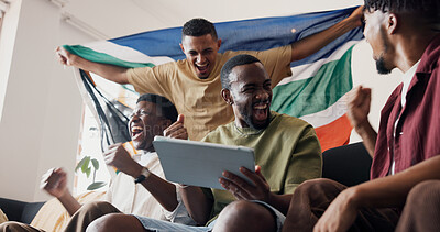 Buy stock photo Soccer game, celebration and men in lounge, tablet and excited for score victory. Live streaming, champion and happy people in home, fans and fist pump for sports tournament or South African flag