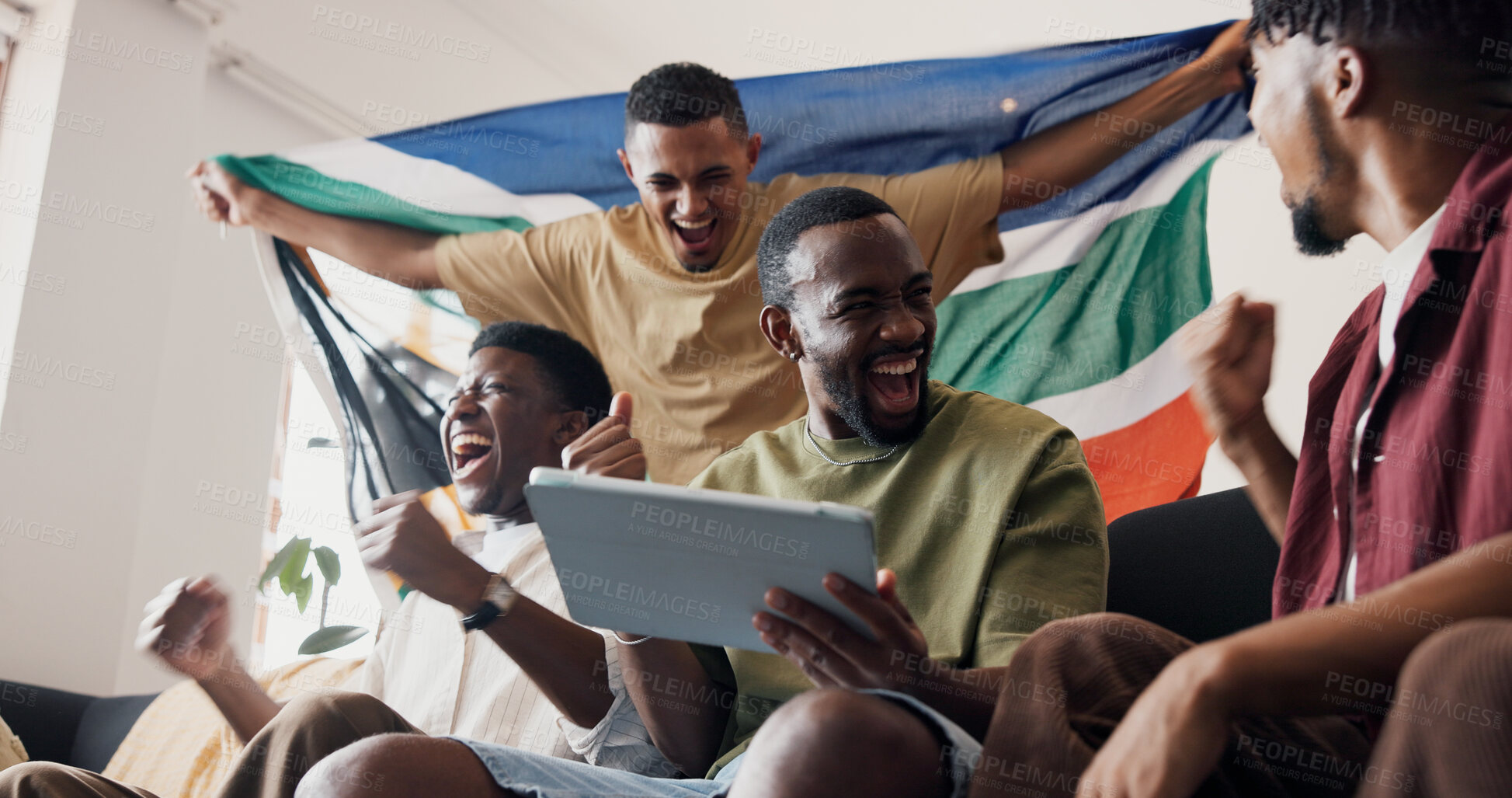 Buy stock photo Soccer game, celebration and men in lounge, tablet and excited for score victory. Live streaming, champion and happy people in home, fans and fist pump for sports tournament or South African flag