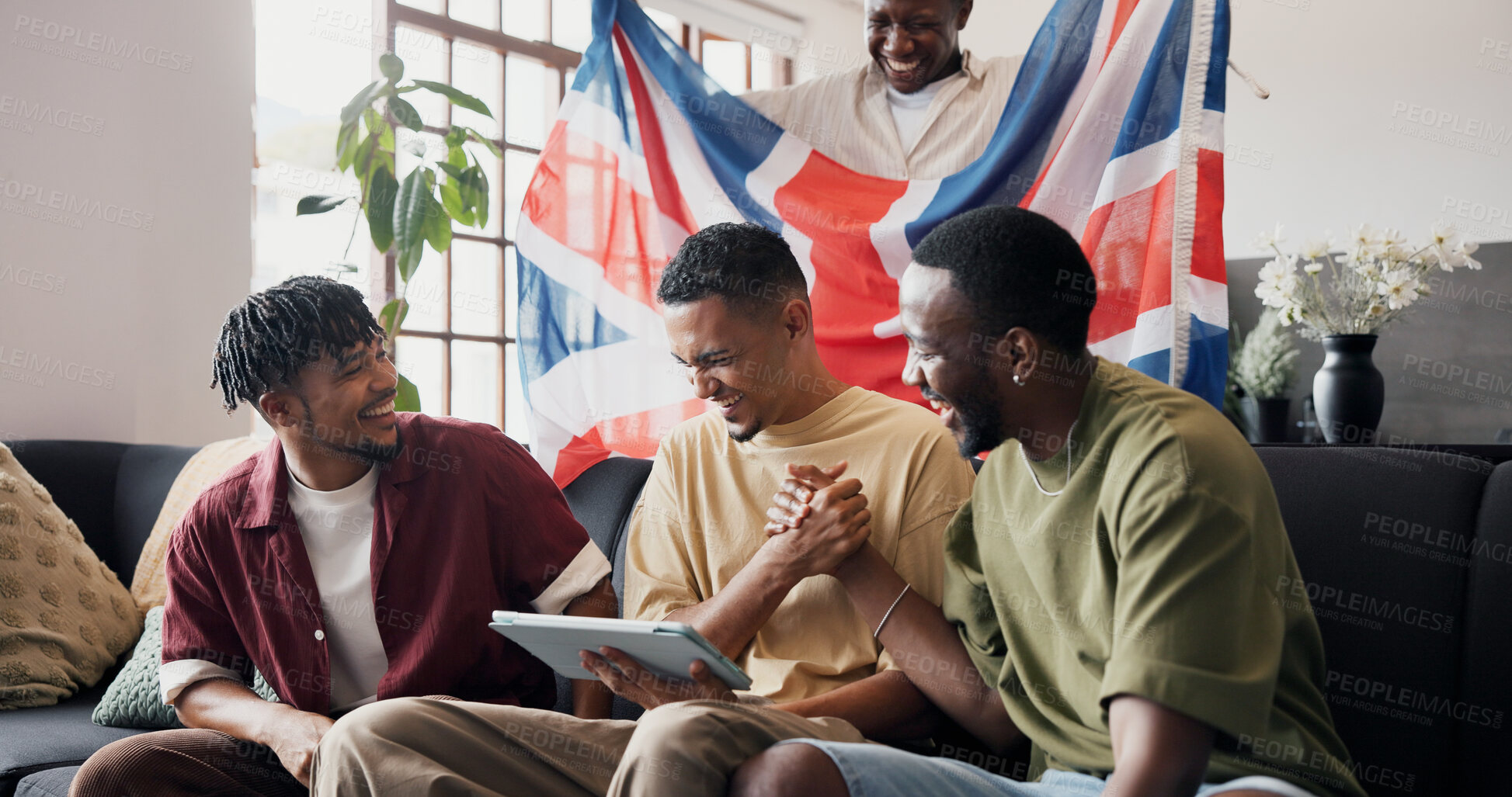 Buy stock photo Football game, handshake and men in home, tablet or celebration for score victory. UK flag, soccer or people in lounge, fans or cheering for sports tournament, live streaming or tech for match update
