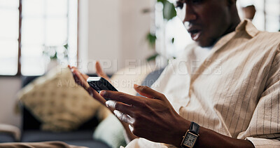 Buy stock photo Hands, phone and texting on sofa in home with shock, gossip or fake news with post in living room. African man, smartphone and surprise with mobile app, notification or social network at apartment