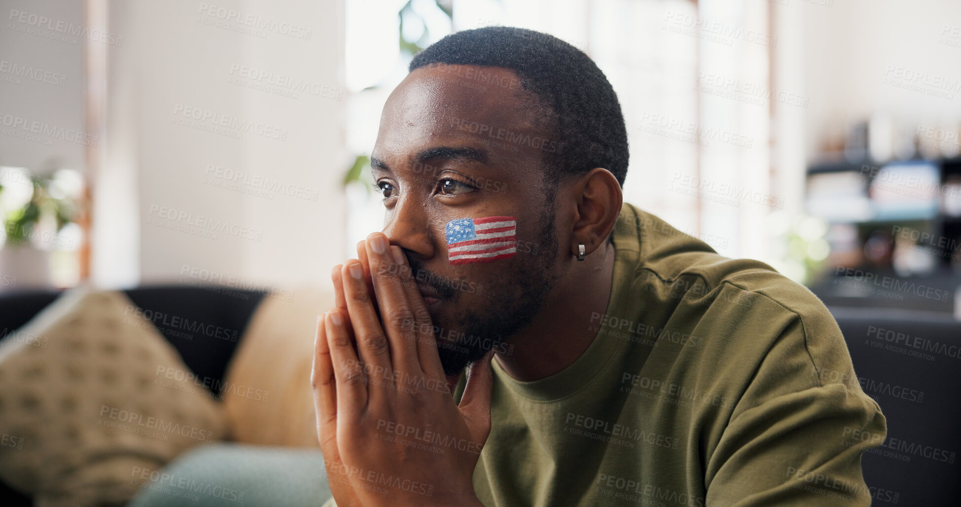 Buy stock photo Man, american and sport with hope in home for live entertainment, match or soccer game on sofa. Male person, football fan or thinking with anticipation for tournament, score or watching tv in house