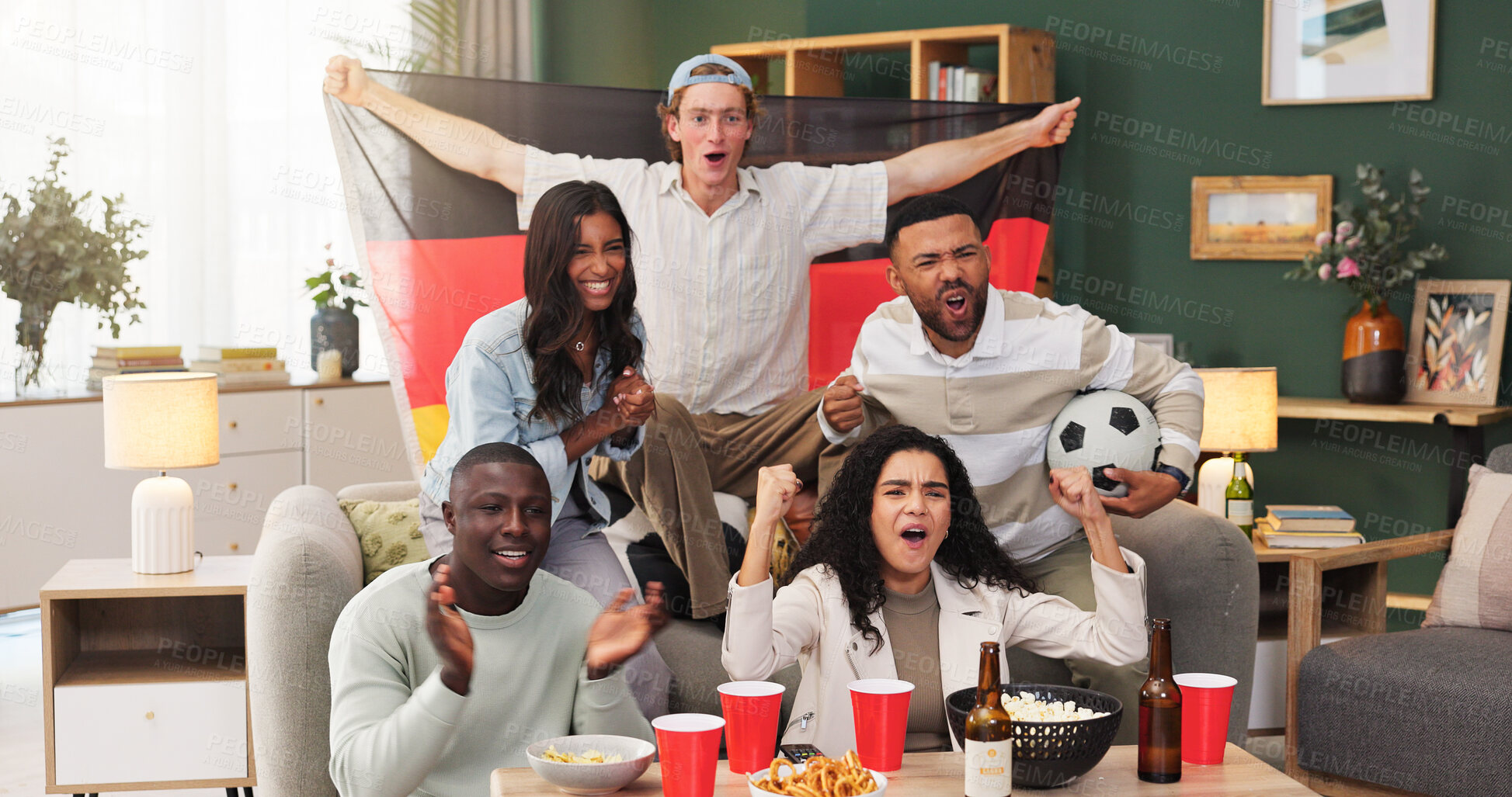 Buy stock photo Excited, fans and people with Germany flag in lounge, watching tv or happiness for football success. Group, together and friends with alcohol for live stream, home and celebration for sport match