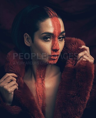 Buy stock photo Confident, woman and fashion with paint in studio for culture, sacred and tribal identity. Portrait, female person and artistic symbol with fur coat, tradition and self expression on black background