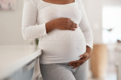 Buy stock photo Pregnancy, expectation or hands in kitchen with belly, fertility or wellness in parenthood. Relax, love and female person in home with stomach touch, motherhood and fetal development in maternal care