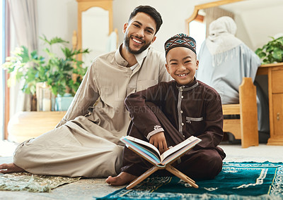 Buy stock photo Quran, portrait and muslim father with child in home studying religion for spiritual wellness together. Arabic, support and islamic dad with boy kid for worship, learning or knowledge on holy book.