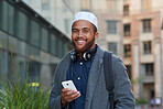 Portrait muslim businessman smiling confident in city holding smartphone 