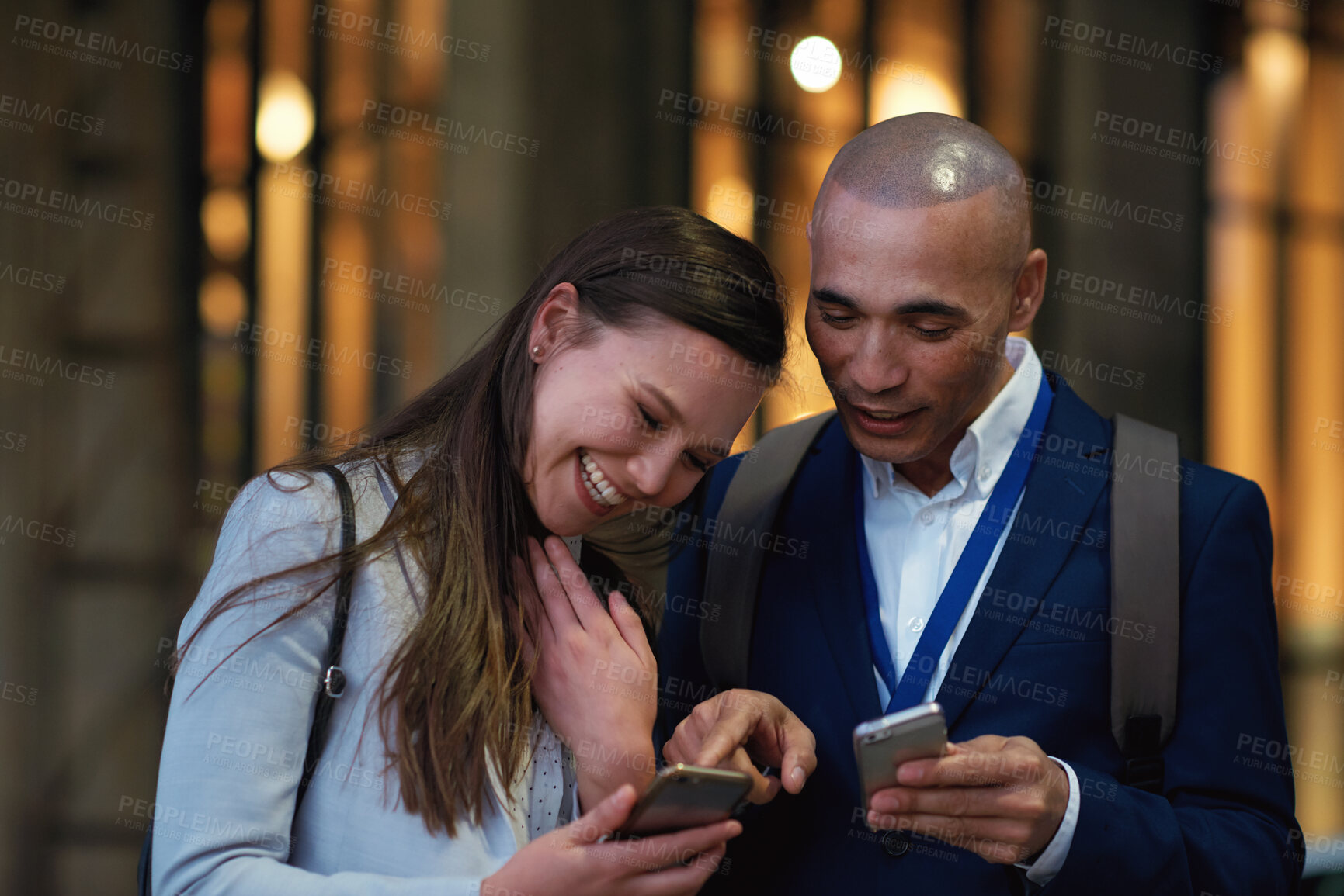 Buy stock photo Business people, night and smartphone in city, funny meme and digital app for social media. Outdoor, man or woman with cellphone, evening or connection for communication, conversation or online humor