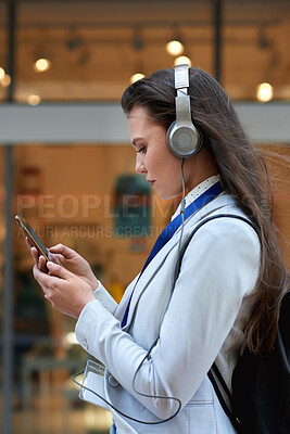 Buy stock photo Scroll, smartphone and businesswoman with headphones in city, commute and communication with contact. Outdoor, commuter and person with mobile for message, reading and listening to music on walk