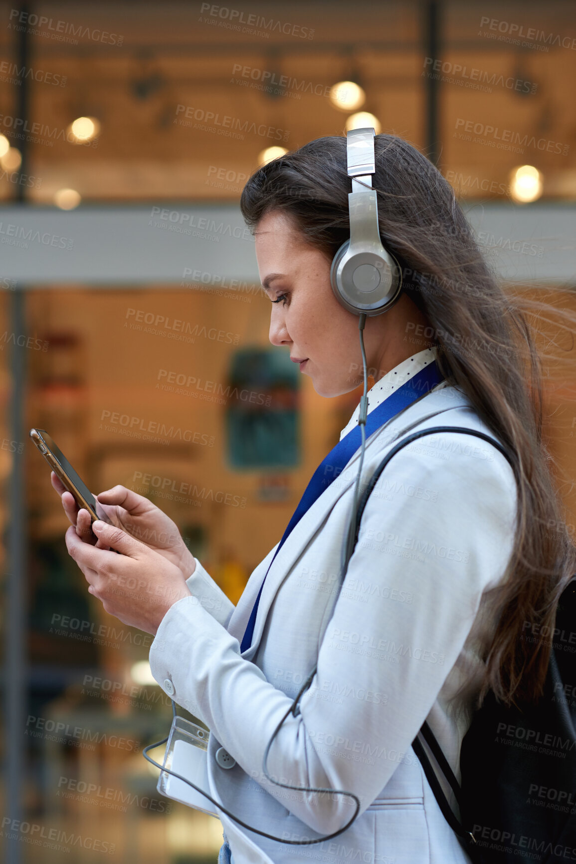 Buy stock photo Scroll, smartphone and businesswoman with headphones in city, commute and communication with contact. Outdoor, commuter and person with mobile for message, reading and listening to music on walk