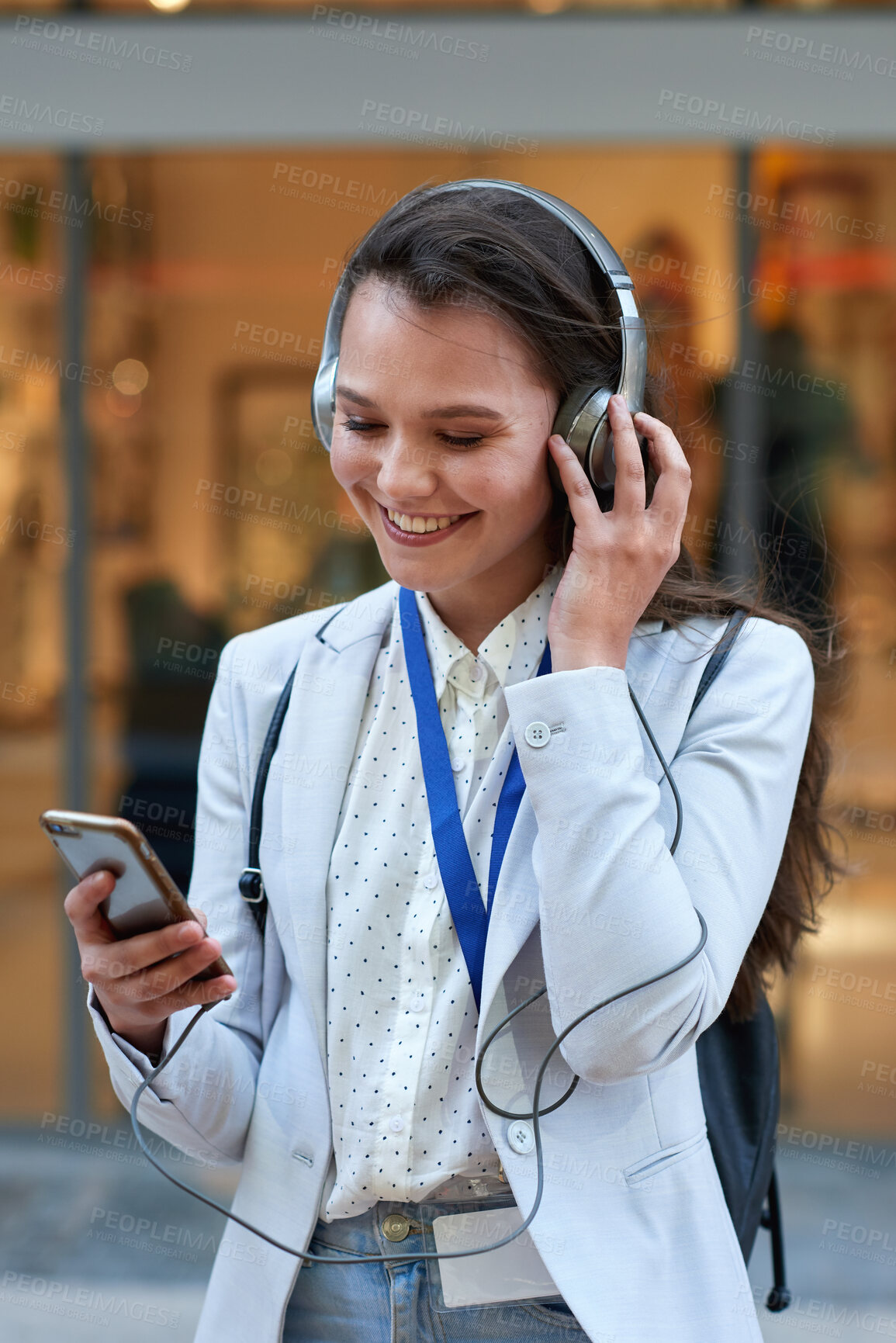 Buy stock photo Headphones, commute and businesswoman with smartphone in city, happy and listening to music on road. Creative, intern and person with smile for audio, travel and app subscription with mobile outdoor