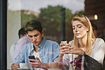 Phone, friends and people at cafe window, relax and check social media, post or typing message. Coffee shop, man and woman with mobile app, text notification and reading blog on internet together