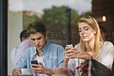 Buy stock photo Phone, friends and people at cafe window, relax and check social media, post or typing message. Coffee shop, man and woman with mobile app, text notification and reading blog on internet together