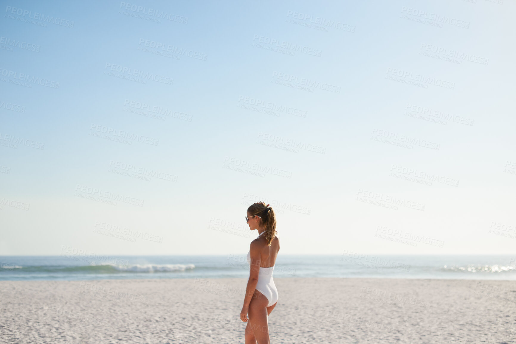 Buy stock photo Woman, walking and relax on beach with summer holiday, swimsuit and sunglasses for weekend getaway. Mockup space, female person and shades outdoor by ocean with peace, reflection or vacation in Miami