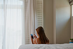 behind shot of beautiful young woman using mobile phone touchscreen