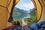 Adventure woman camping at beautiful lake inside yellow tent view of majestic mountain inspiration escape