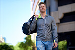 confident young man smiling happy walking in city street holding bag enjoying urban lifestyle