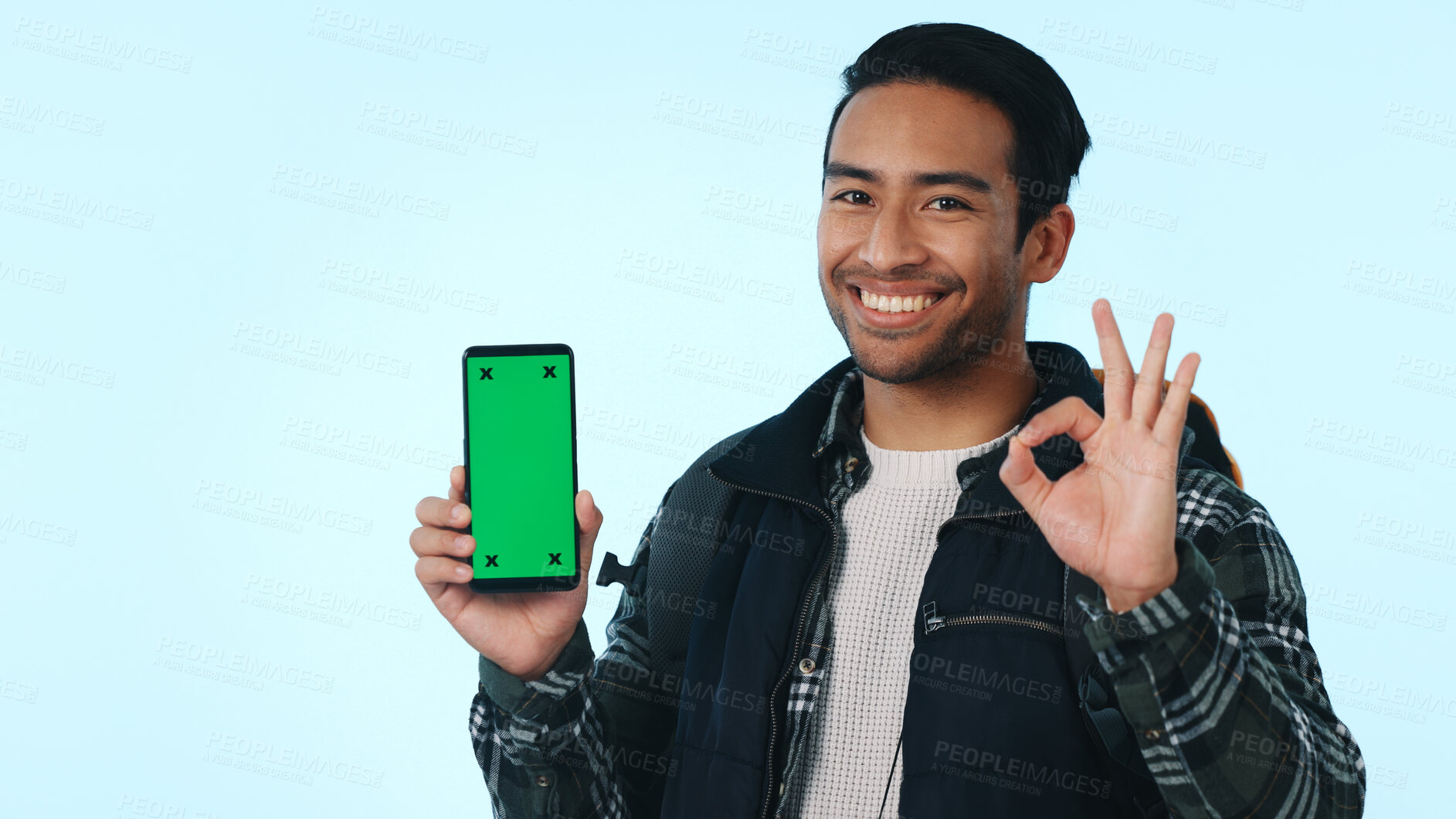 Buy stock photo Green screen, hiker and happy man with phone, portrait and recommendation for social media or travel. Blue background, marketing and person with ok hand gesture for mobile, studio and mockup space