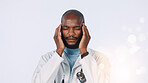Black man, doctor and headache with stress in studio for pressure on a white background. Frustrated, male person or healthcare worker with migraine or sore ache on bokeh for medical mistake or strain