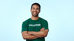 Volunteer, man or happy with arms crossed in studio for earth day NGO, non profit aid or about us. Space, laugh portrait or activist on blue background for community service, charity or green project