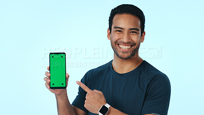 Buy stock photo Green screen, portrait and happy man with phone, pointing and recommendation for social media or web. Blue background, mockup space and person with smile for mobile app, promotion and tech in studio