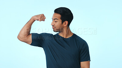 Buy stock photo Fitness, flex and man with muscle in studio with pride for exercise, workout progress or results. Space, mockup and confident person with biceps for health, wellness or bodybuilder on blue background