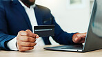 Credit card, hands and business person with laptop for fintech, password and online transaction. Typing, investor and man in office for banking, purchase or payment for ecommerce and procurement