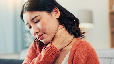 Buy stock photo Neck pain, stress and Asian woman on sofa with injury for fibromyalgia, osteoporosis and inflammation. Home, massage and person on couch with strain, muscle tension and pressure in living room