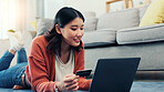Credit card, laptop and Asian woman in home for online shopping, digital subscription or internet payment. Home, floor and person with bank info on computer for purchase, transaction and ecommerce