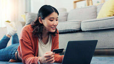 Buy stock photo Credit card, laptop and Asian woman in home for online shopping, digital subscription or internet payment. House, floor and person with bank info on computer for purchase, transaction and ecommerce