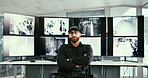 Security guard, monitor or man with arms crossed for portrait, camera surveillance or crime prevention. Serious, computer screen or safety officer with cctv in control room, pride or protect property