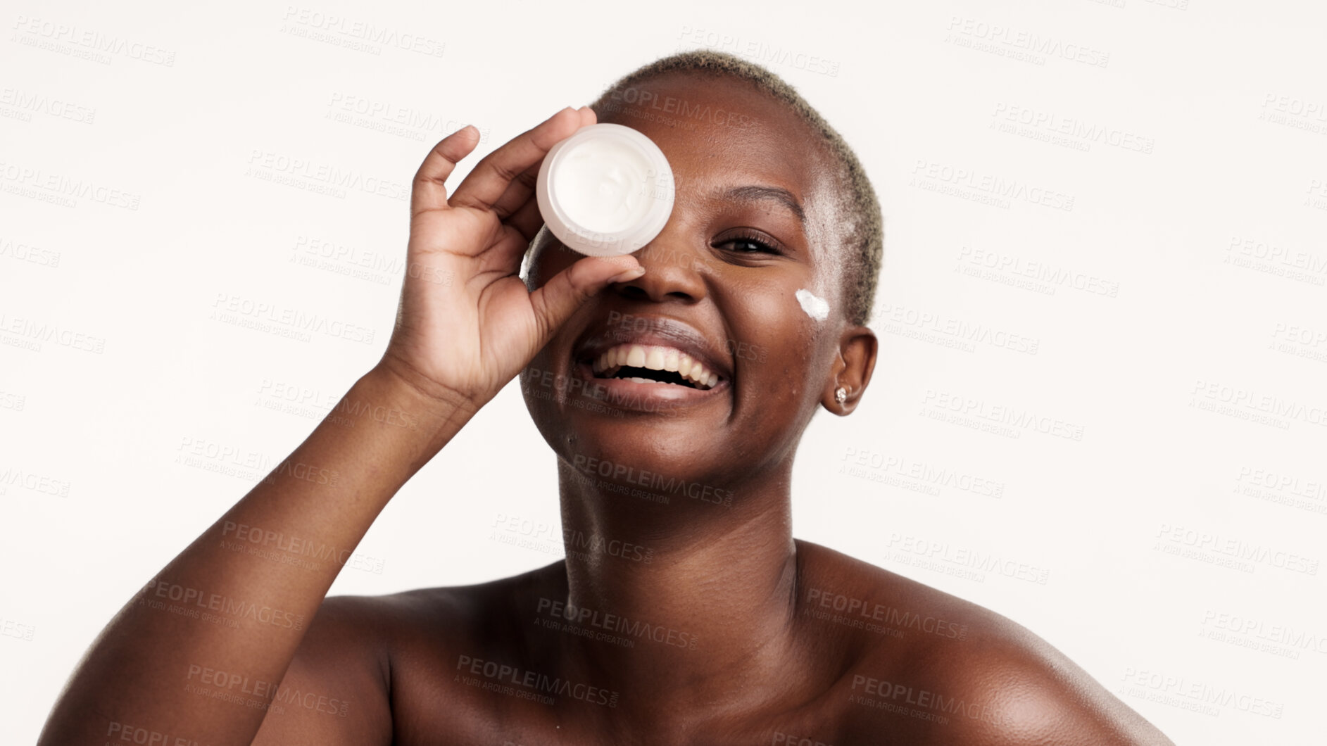Buy stock photo Portrait, skincare and black woman in studio with face cream, lotion container and antiaging benefits. Person, smile and apply moisturizer for dermatology, wellness or clear skin on white background.