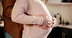 Hug, couple or pregnant woman with hands in kitchen of home, connection or tummy touch for family growth. Love, embrace or people with baby kick for bonding, maternity support or future parents