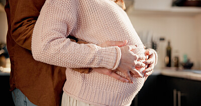 Buy stock photo Hug, couple or pregnant woman with hands in kitchen of home, connection or tummy touch for family growth. Love, embrace or people with baby kick for bonding, maternity support or future parents