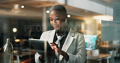 Buy stock photo Night, reading or woman with tablet in agency, publishing deadline or review story for digital media site. Glass, tech or African journalist with grammar check app, news article editing or overtime