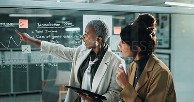 Buy stock photo Women, tablet and team at glass wall in office at night, graphs and reconciliation sheet at finance company. Business people, tech and app at window, feedback or review for asset management agency
