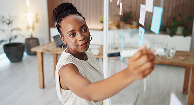 Buy stock photo Black woman, writing or planning with glass board in office for schedule, tasks or agenda. Female person, employee or taking notes with marker for brainstorming ideas or project reminder in workplace