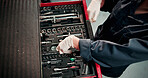 Man, hands and mechanic with tools in workshop for repairs, maintenance or fixing car. Technician, engineer and male industrial worker with bolt equipment for vehicle calibration test in factory.