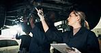Mechanic, workshop and people on tablet with car for inspection, report and vehicle diagnostics. Team, garage and woman with tech for motor repair, maintenance and technician for engine service
