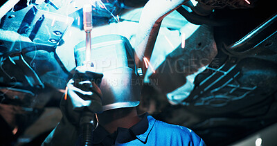 Buy stock photo Mechanic, welding and person with helmet by car for diagnostics, maintenance and auto service. Workshop, sparks and technician with equipment for vehicle inspection, fixing and engine repair