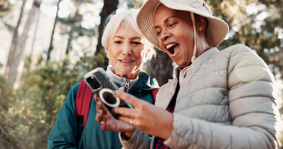 Buy stock photo Hiking, excited and senior women with phone for wellness, fresh air and online app for navigation. Friends, shock and elderly people on smartphone for direction, trekking and exercise on nature trail