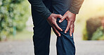 Park, fitness and hands of man with knee pain for strain after exercise, workout and running. Nature, sports and person with leg injury for joint ache, inflammation and accident for training outdoor
