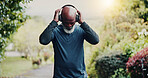 Outdoor, fitness and old man with headphones at park, reflection and listening to music for workout. Streaming, space and senior black person with tech for audio, retirement and exercise for wellness
