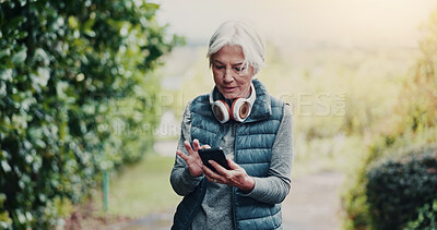 Buy stock photo Outdoor, reading or old woman with phone for fitness, running route research or find training playlist. Park, workout app or senior person with tech for trail navigation, steps count or music search