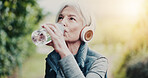 Outdoor, headphones and old woman with water for fitness, think and listen to music on workout break. Park, space and senior person with tech for audio, retirement and liquid after exercise in nature
